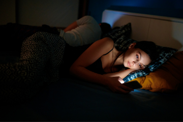 woman on her phone in bed